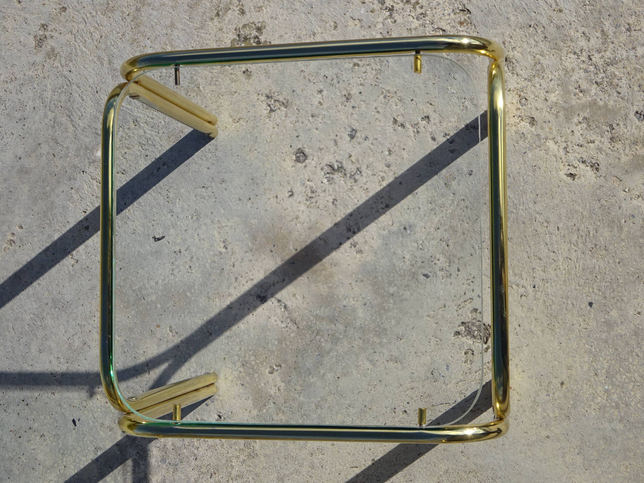 Nested tubular tables in gold metal.
