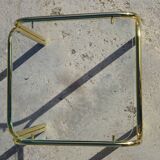 Nested tubular tables in gold metal.