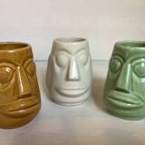 Set of three small Moai-style head vases.