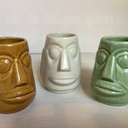 Set of three small Moai-style head vases.
