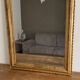 Golden mirror from the late 19th century with a decorated pediment. 130x74.