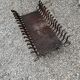 Vintage cast iron fireplace cradle with 16 bars.
