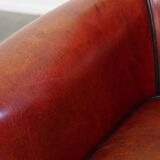 Armchair made of sheepskin leather in a red/brown color