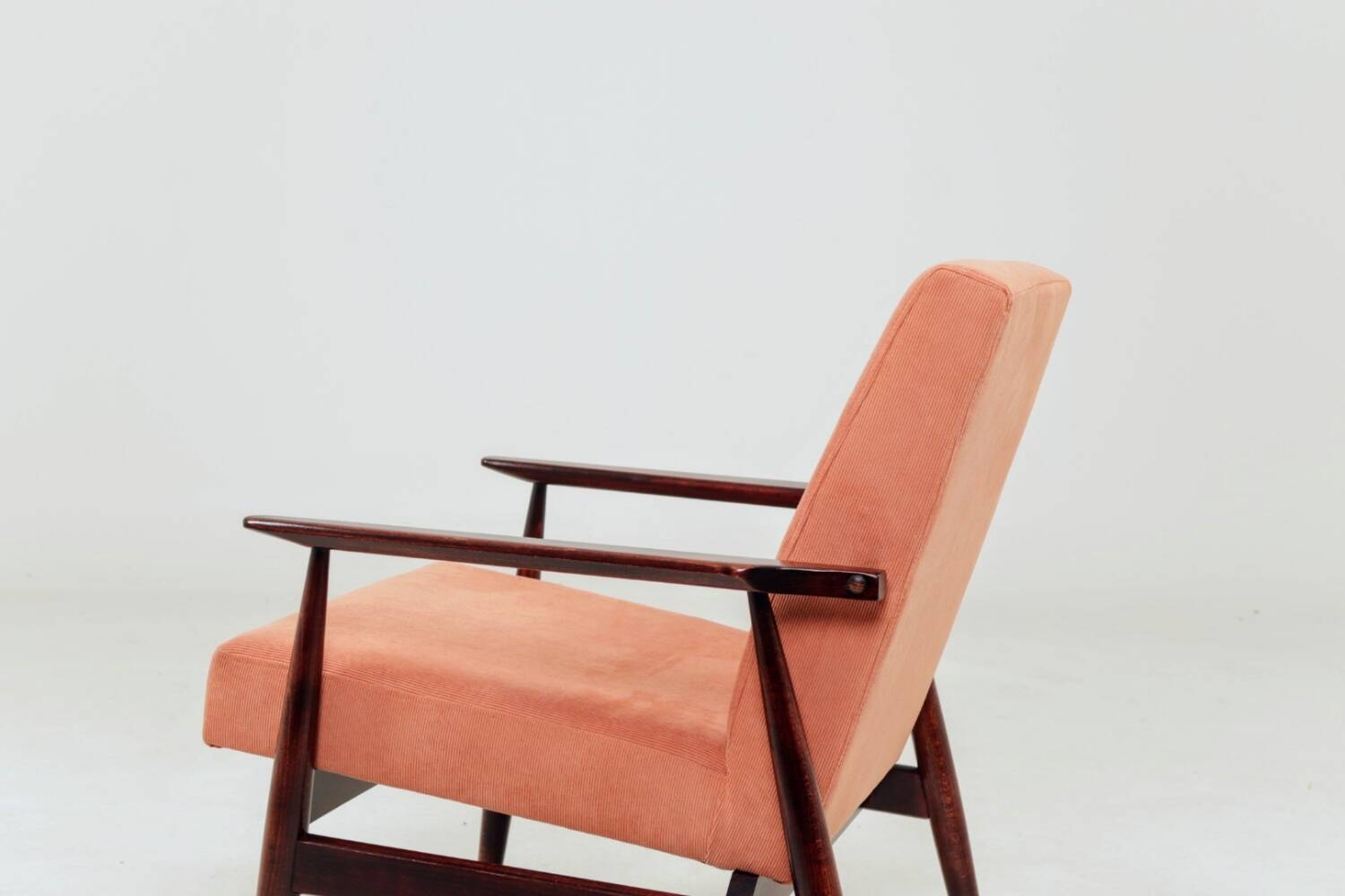 Mid-century modern armchair in coral red designed by H. Lis.