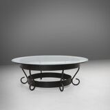 Rustic round coffee table with wrought iron base and glass top, France, 1930s