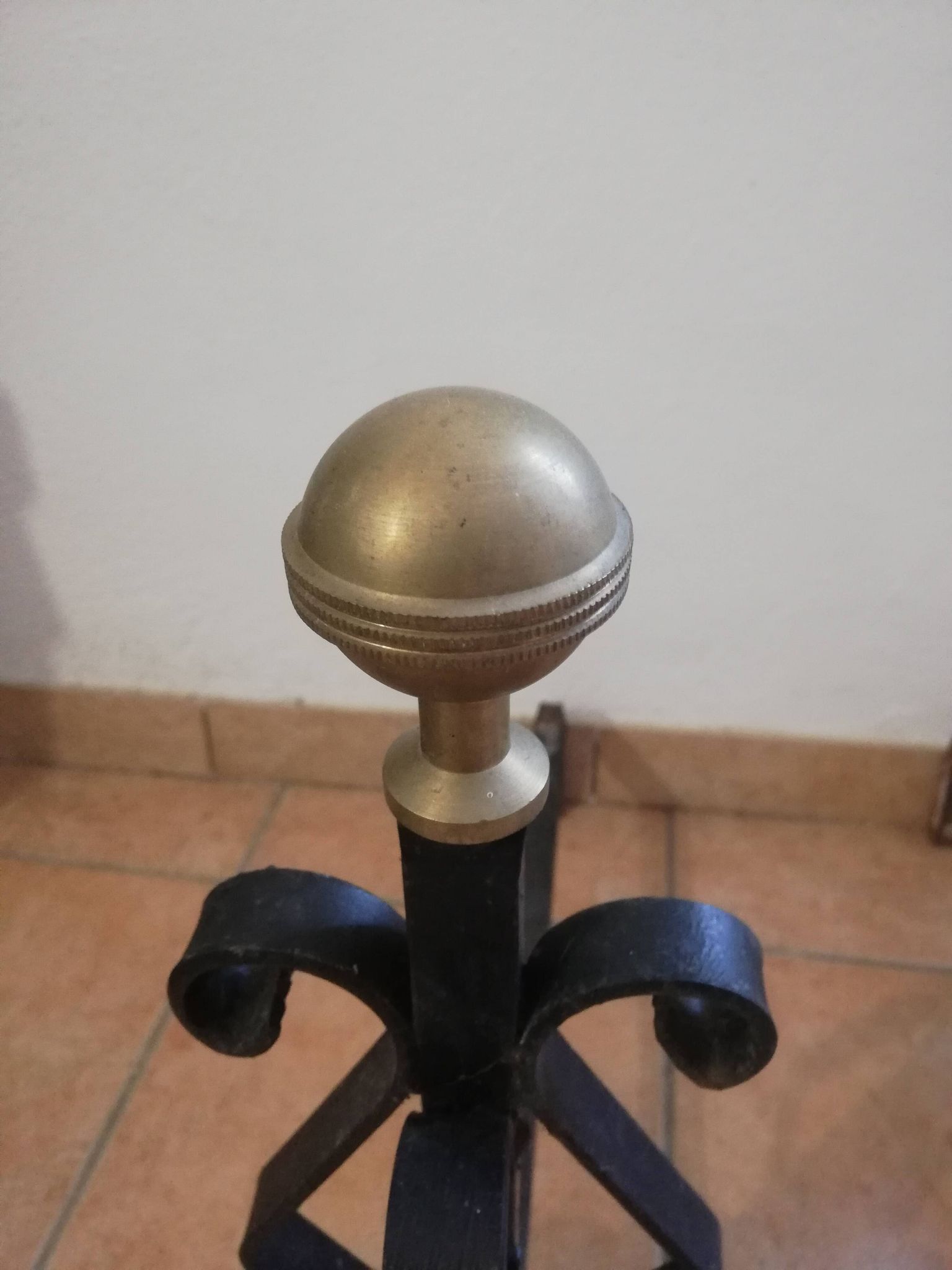 Pair of wrought iron andirons and brass ball.