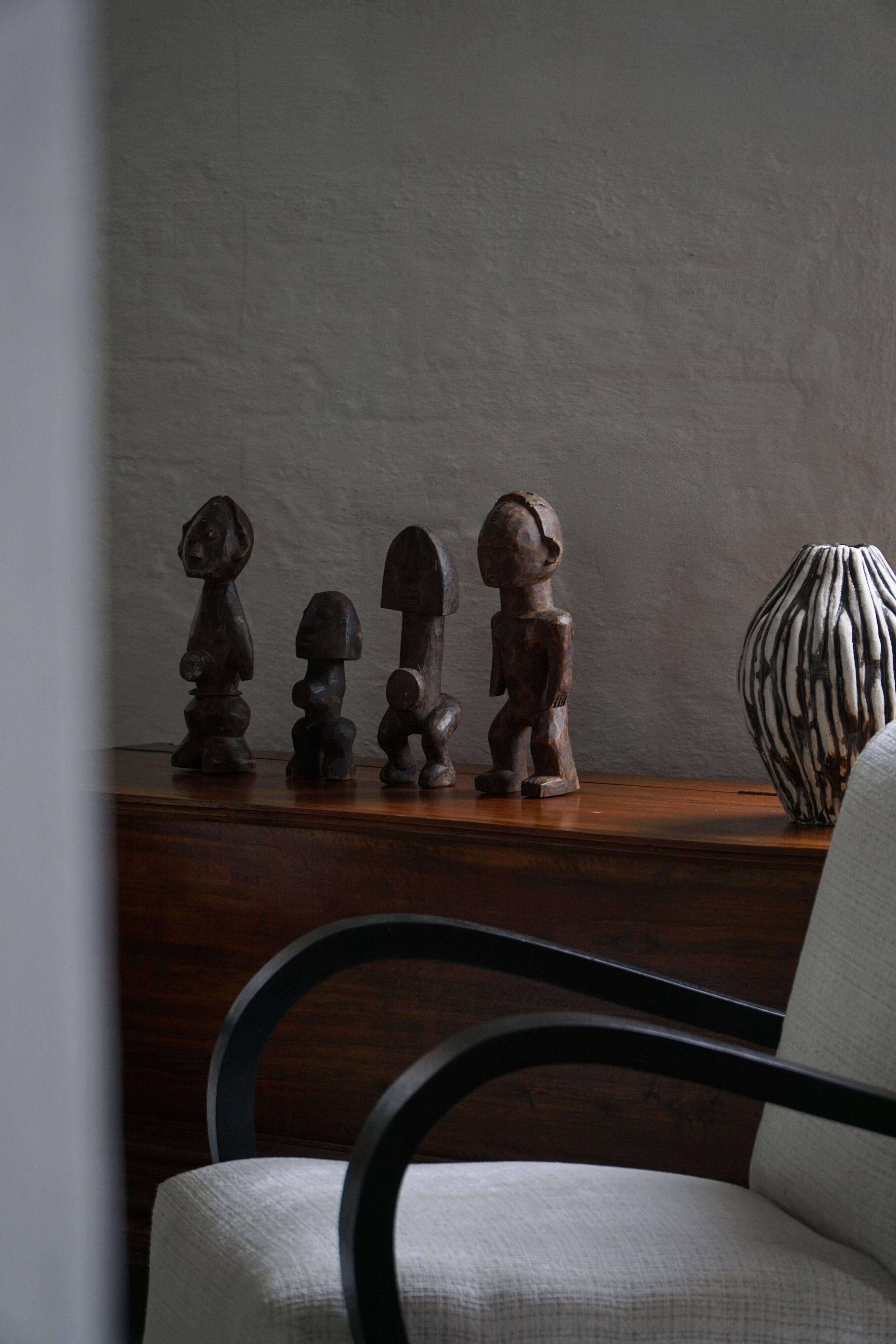 Set of 4 decorative handcrafted African wooden sculptures, mid-century.