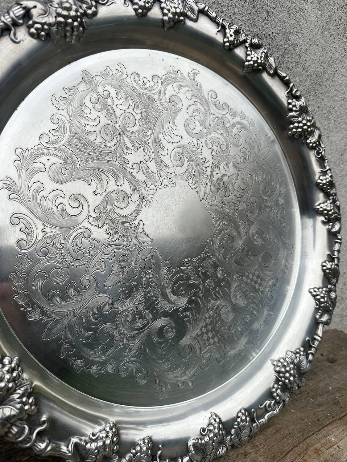 Antique round silver serving platter, grape motifs.