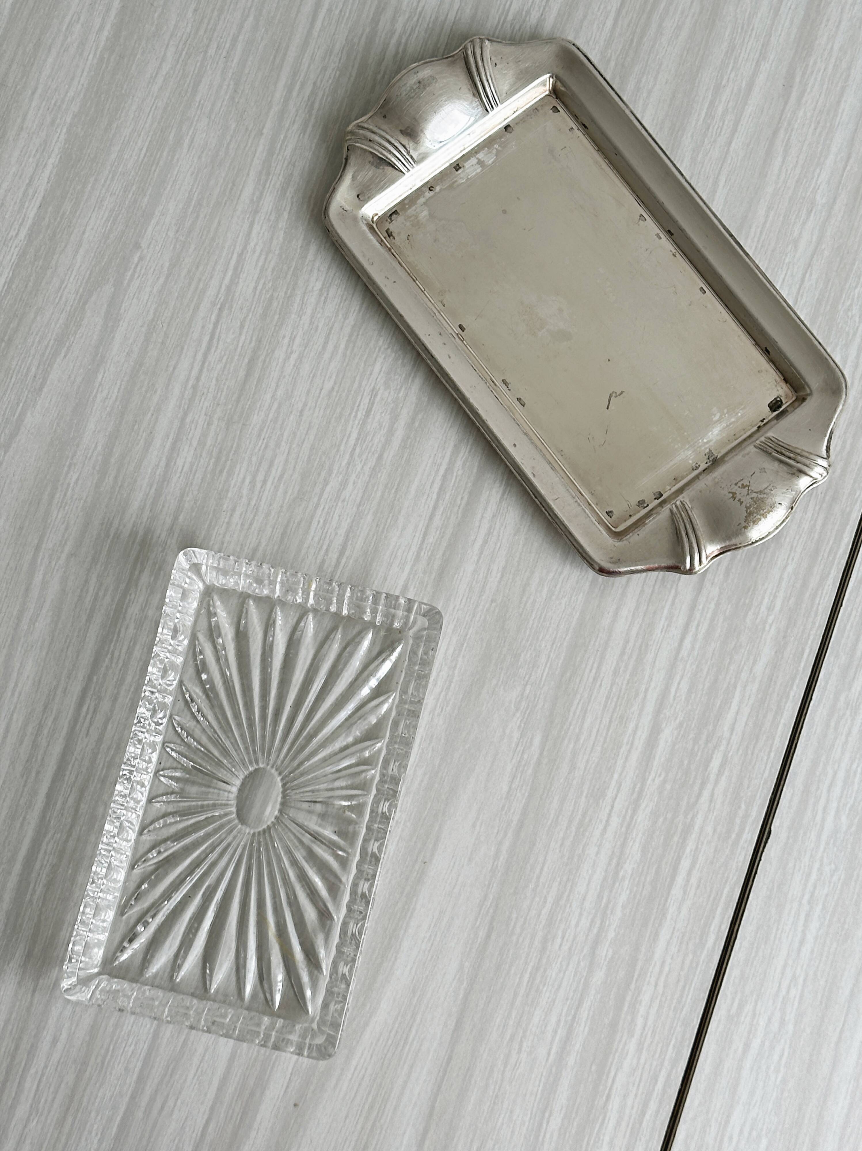 Metal butter dish and thick rectangular glass bowl.