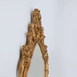 French Rococo or Baroque style facet-cut crest mirror in gilded carved wood