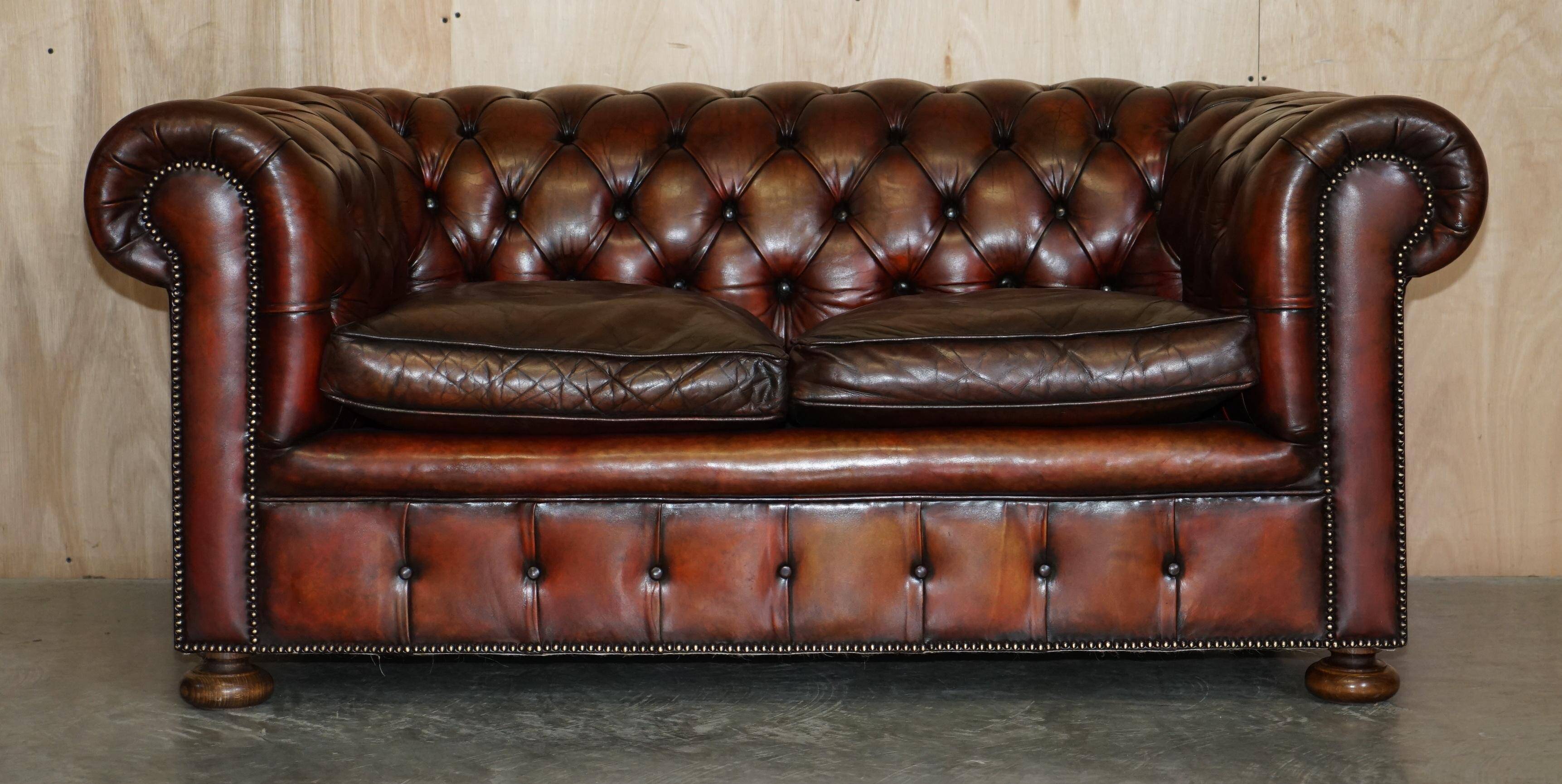 Pair of restored antique Chesterfield sofas in Boudreaux leather.