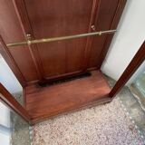 Antique wooden coat rack with mirror and shelf.