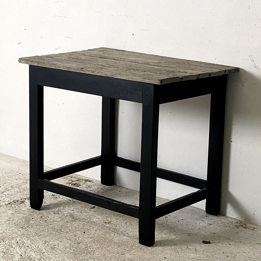 Old blackened wood work table and varnished top