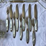 Old brass forks and knives and mother-of-pearl handle
