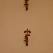 A pair of antique brass wall sconces.