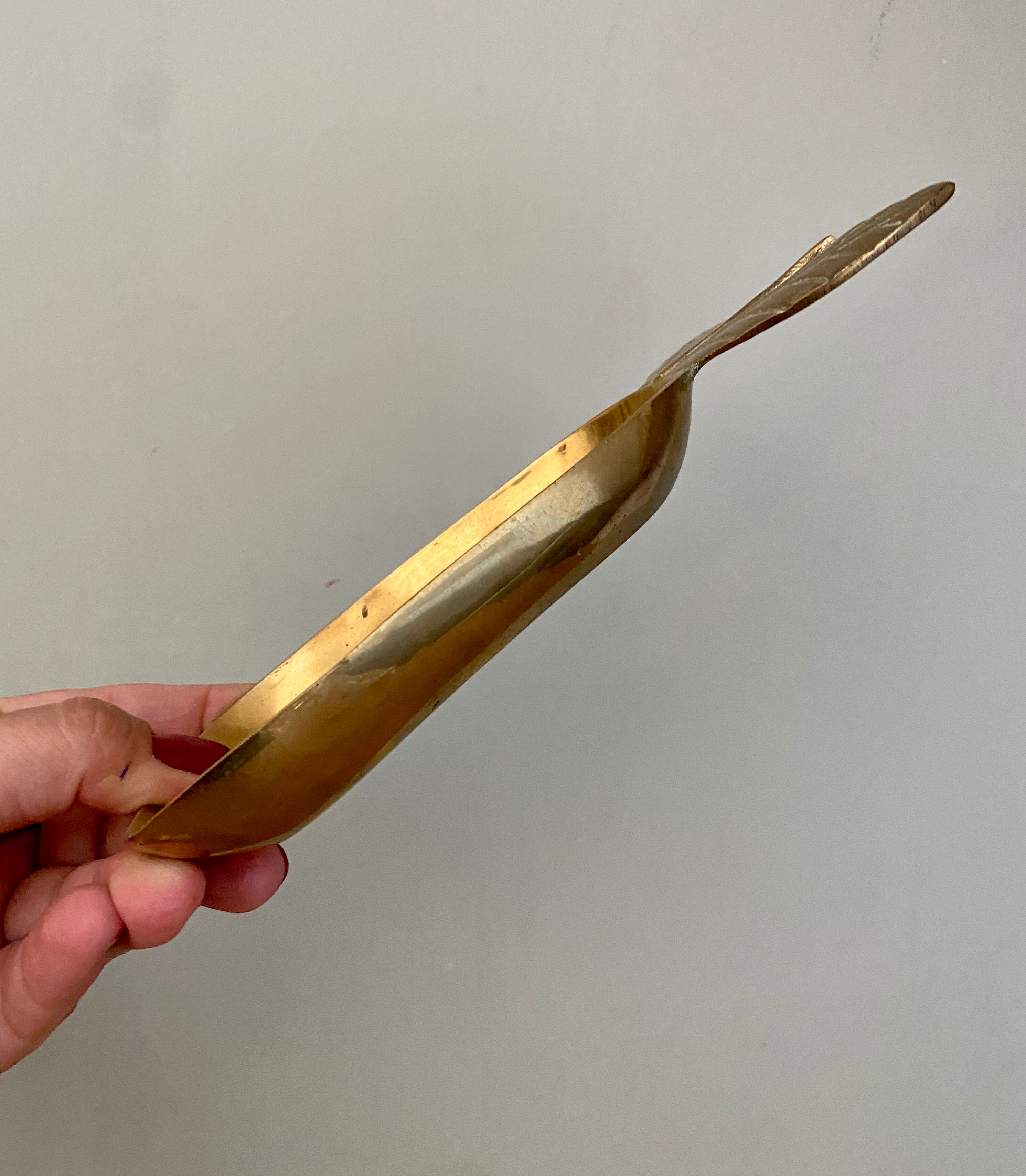 Empty vintage pear-shaped brass pocket