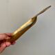 Empty vintage pear-shaped brass pocket