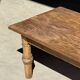 Brown Indonesian teak coffee table, with a border and cylindrical legs H40 L103.