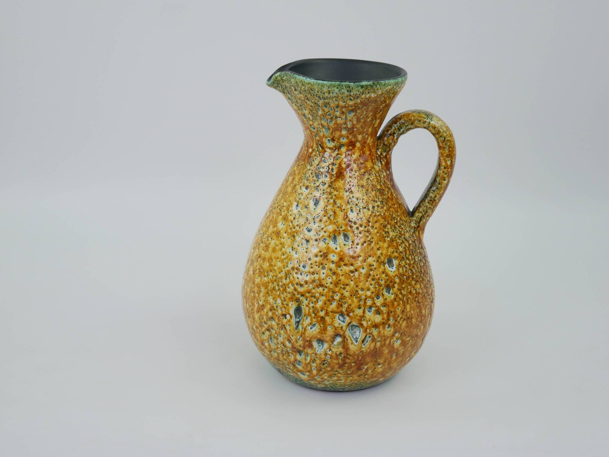 Large yellow ceramic pitcher in the Accolay style