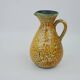Large yellow ceramic pitcher in the Accolay style