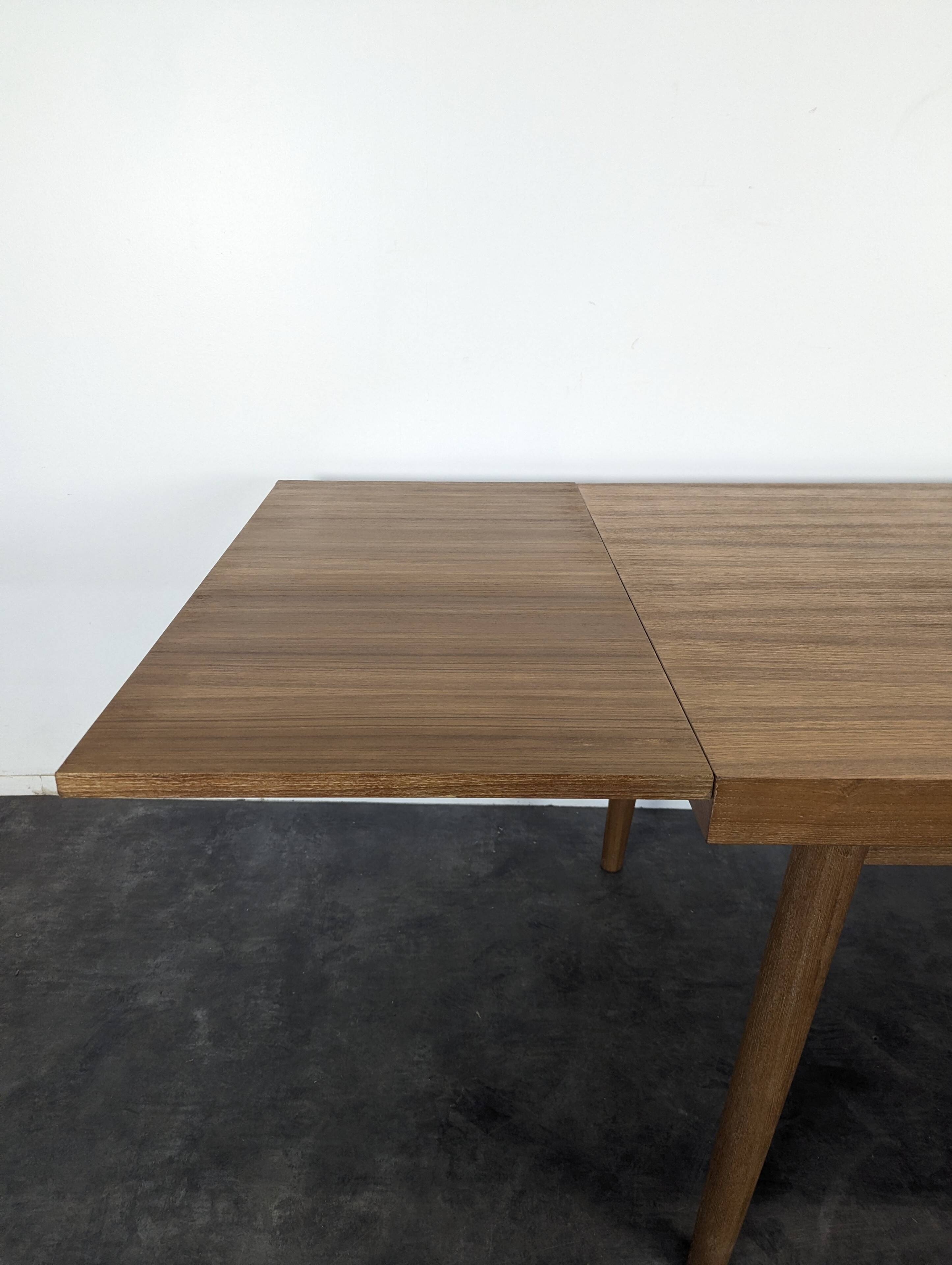 Modernist teak table with 2 extensions.