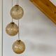 Suspension cascade trois feux globes vintage en verre ambré