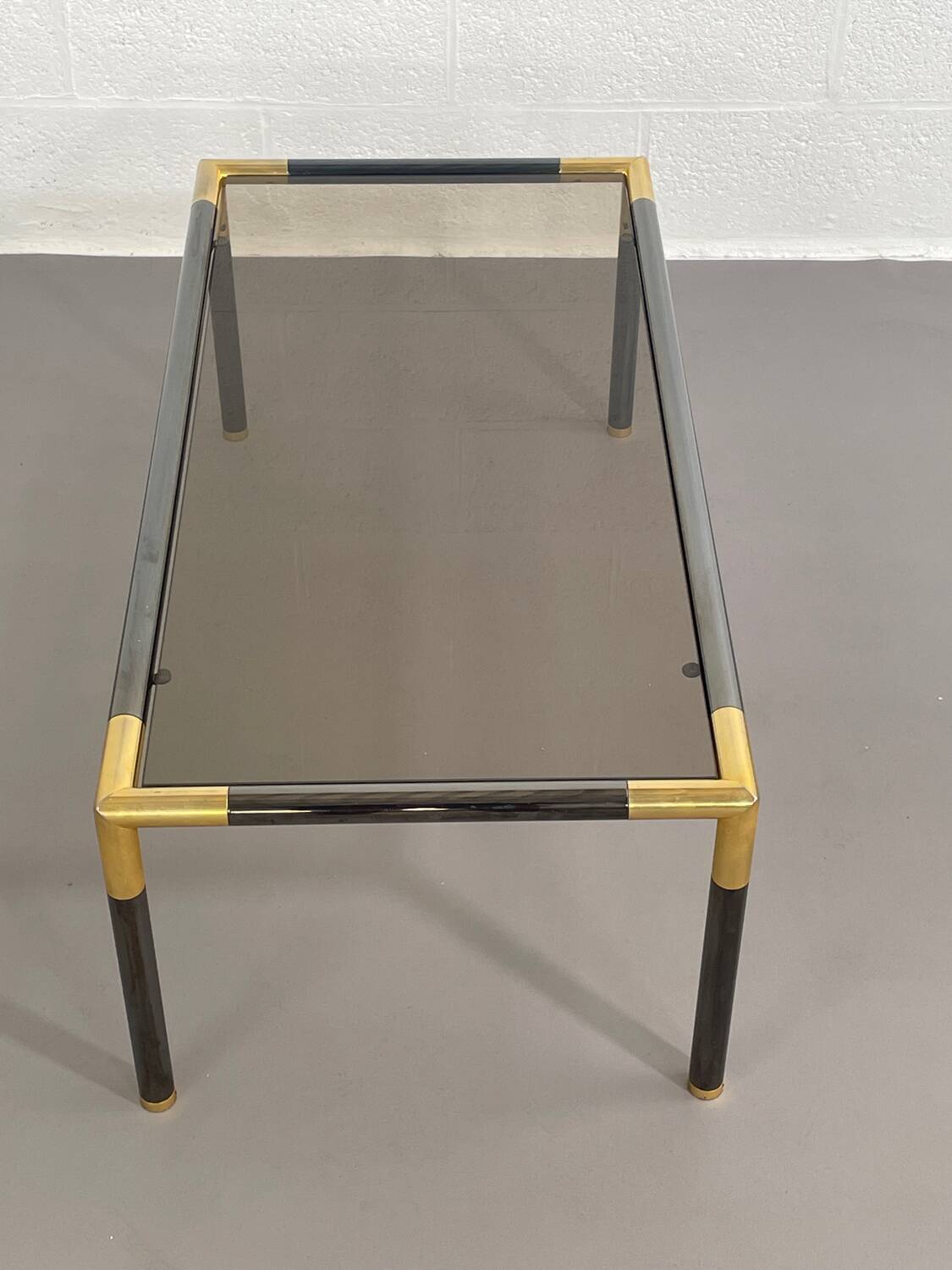 Gunmetal gold metal and smoked glass coffee table from the 70s