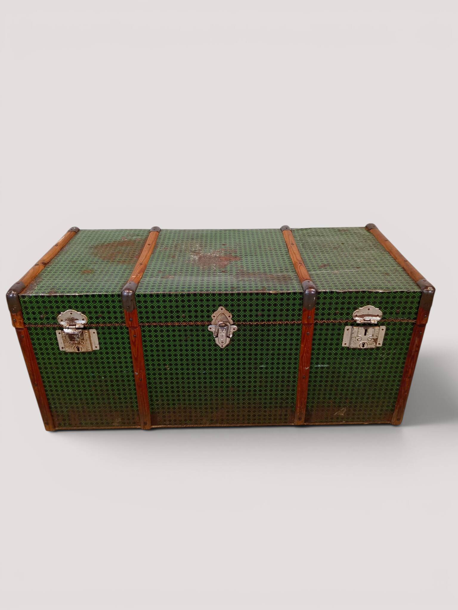Vintage wooden and metal green travel trunk, circa 1930.