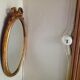 Miroir médaillon en bois doré - 43x24cm