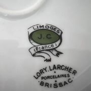 Round porcelain plate from Limoges with a hydrangea basket design.