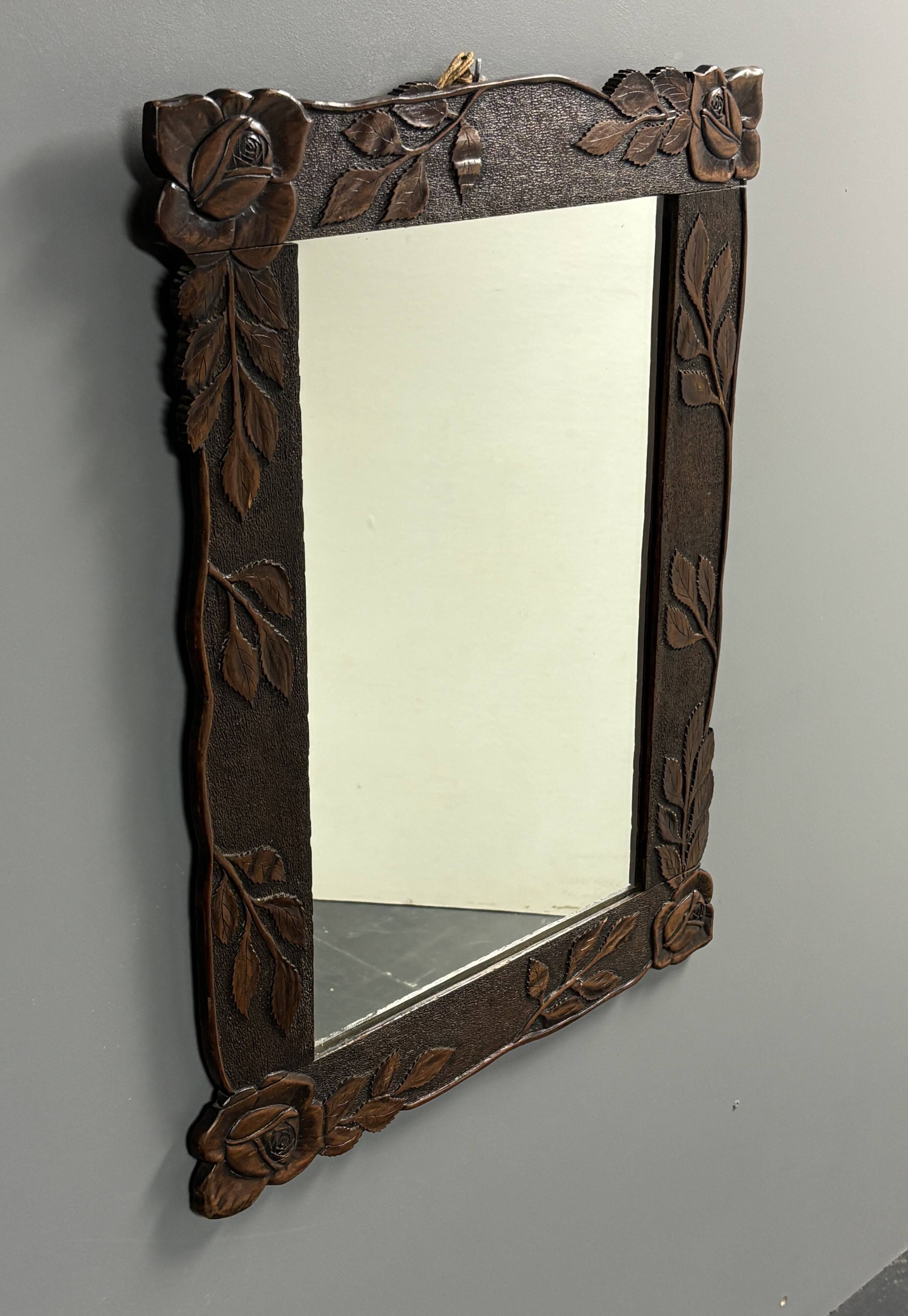 Arts & Crafts hand-carved wall mirror with floral roses, early 20th century