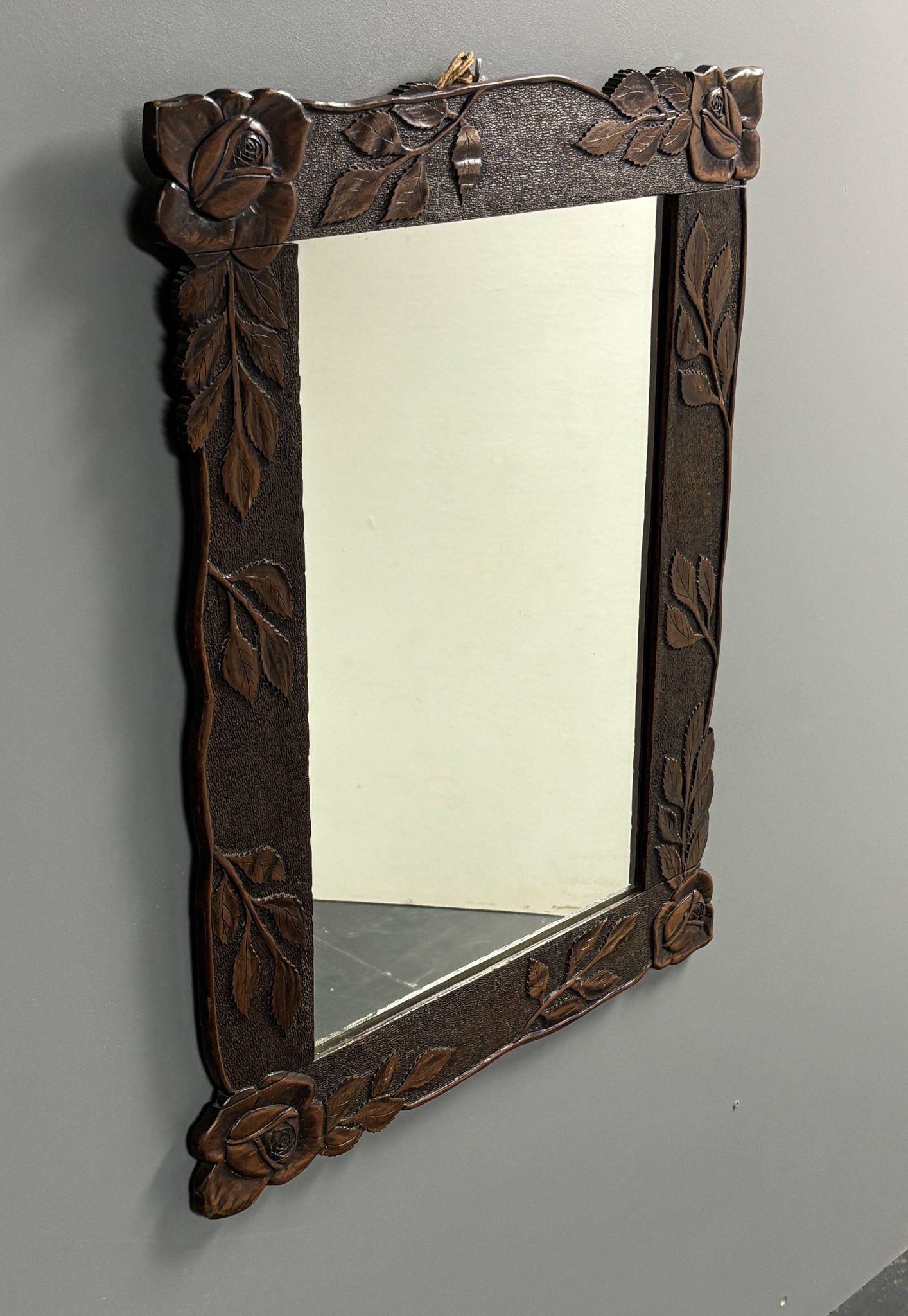Arts & Crafts hand-carved wall mirror with floral roses, early 20th century