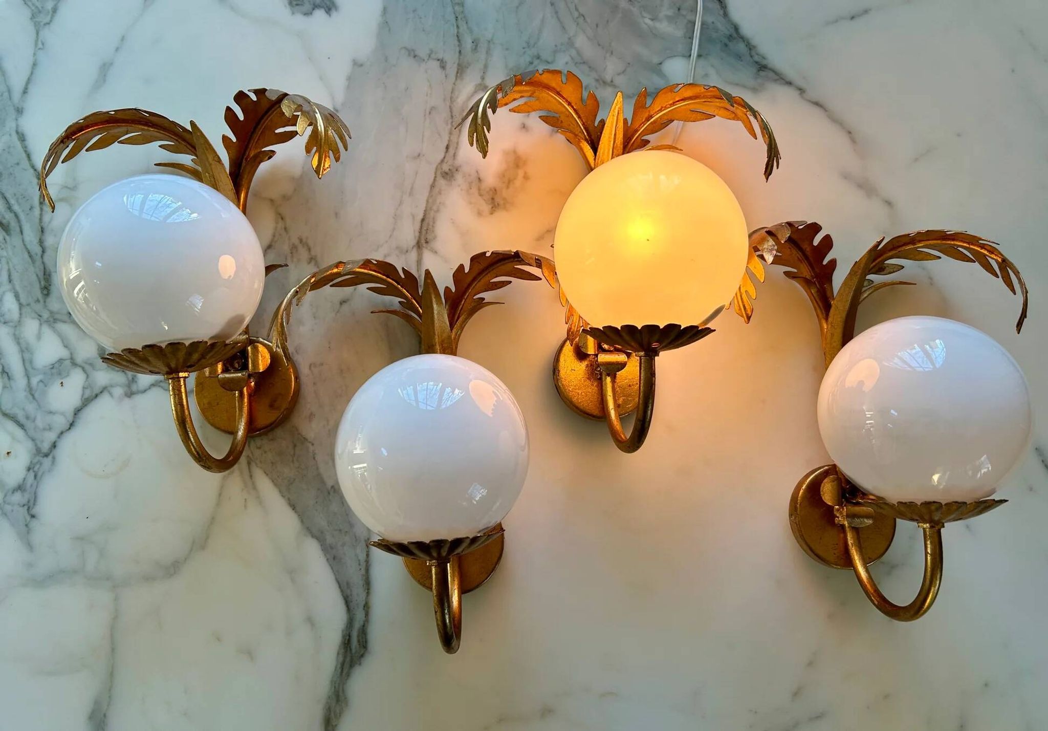 Pair of palm leaf wall lights in Hollywood Regency style with opaque globes by Hans Kögl, Germany, 1970s.