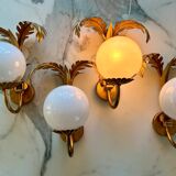 Pair of palm leaf wall lights in Hollywood Regency style with opaque globes by Hans Kögl, Germany, 1970s.