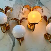 Pair of palm leaf wall lights in Hollywood Regency style with opaque globes by Hans Kögl, Germany, 1970s.