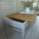 Coffee table made from an authentic farmhouse table, leg patinated pearl gray