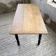 Oak farmhouse table with turned black legs.