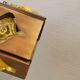 Older hanging lamp, made of metal with yellow prisms.