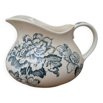 Ceramic water jug with blue floral decoration.