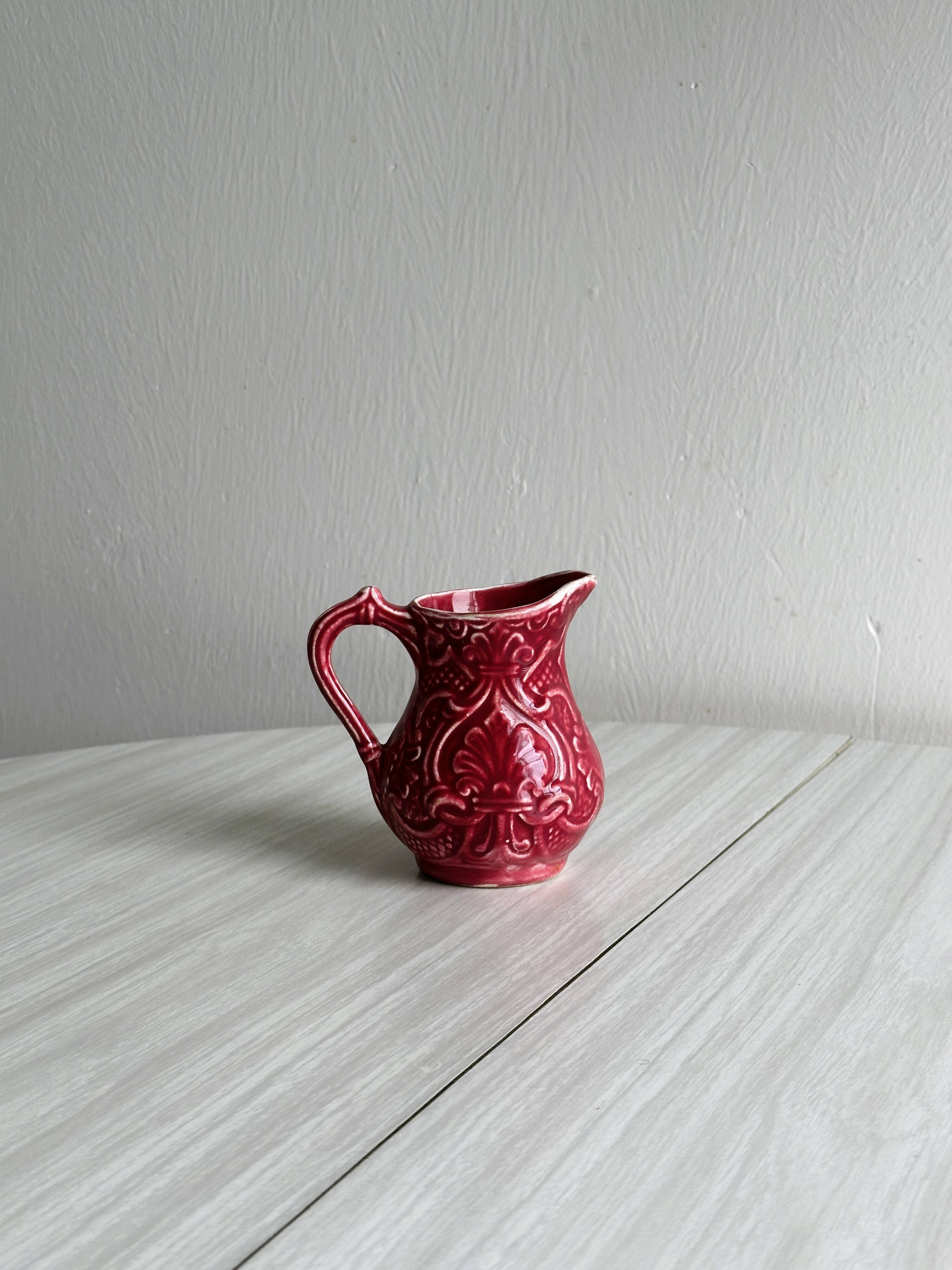 Red ceramic milk jug