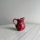 Red ceramic milk jug