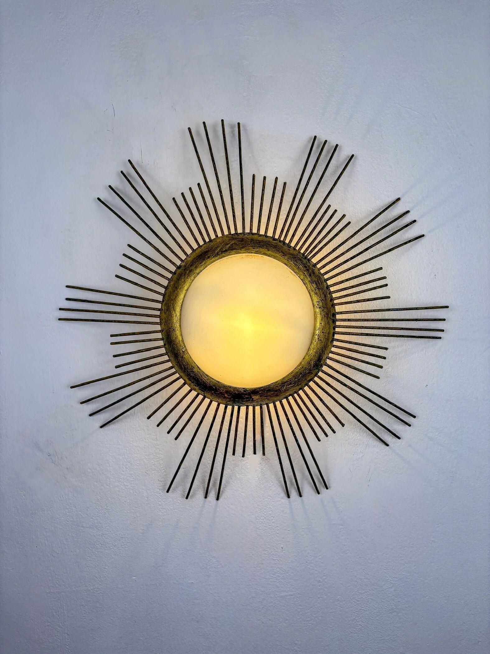 Large sunburst brutalist ceiling flush mount or pendant – gilt iron rays & opaline, France, 1950s