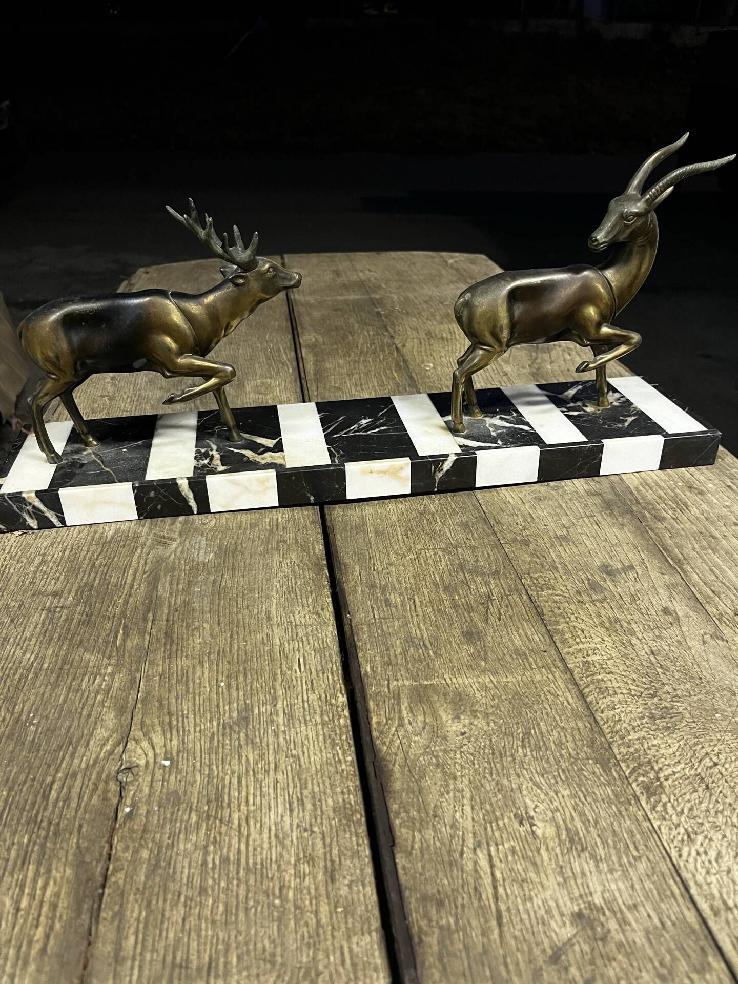 Bronze sculpture of a deer and doe in an Art Deco animal scene on a base.