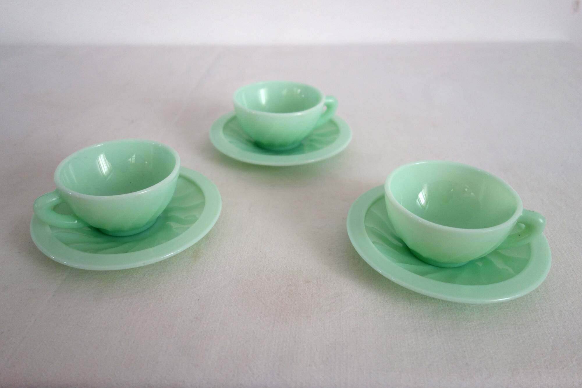 10 almond green opaline cups and saucers from the 50s