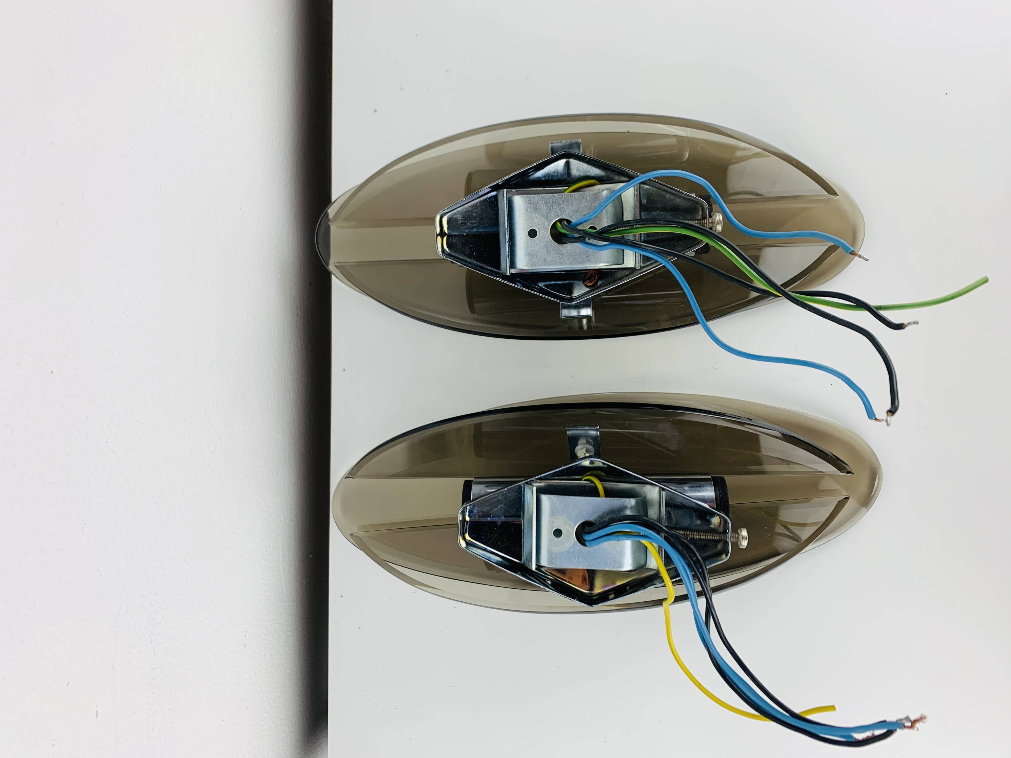 Pair of smoked glass and chrome wall lights from the 1970s.