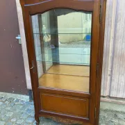Louis XV style display cabinet in cherry wood with a mirrored back and glass shelves.