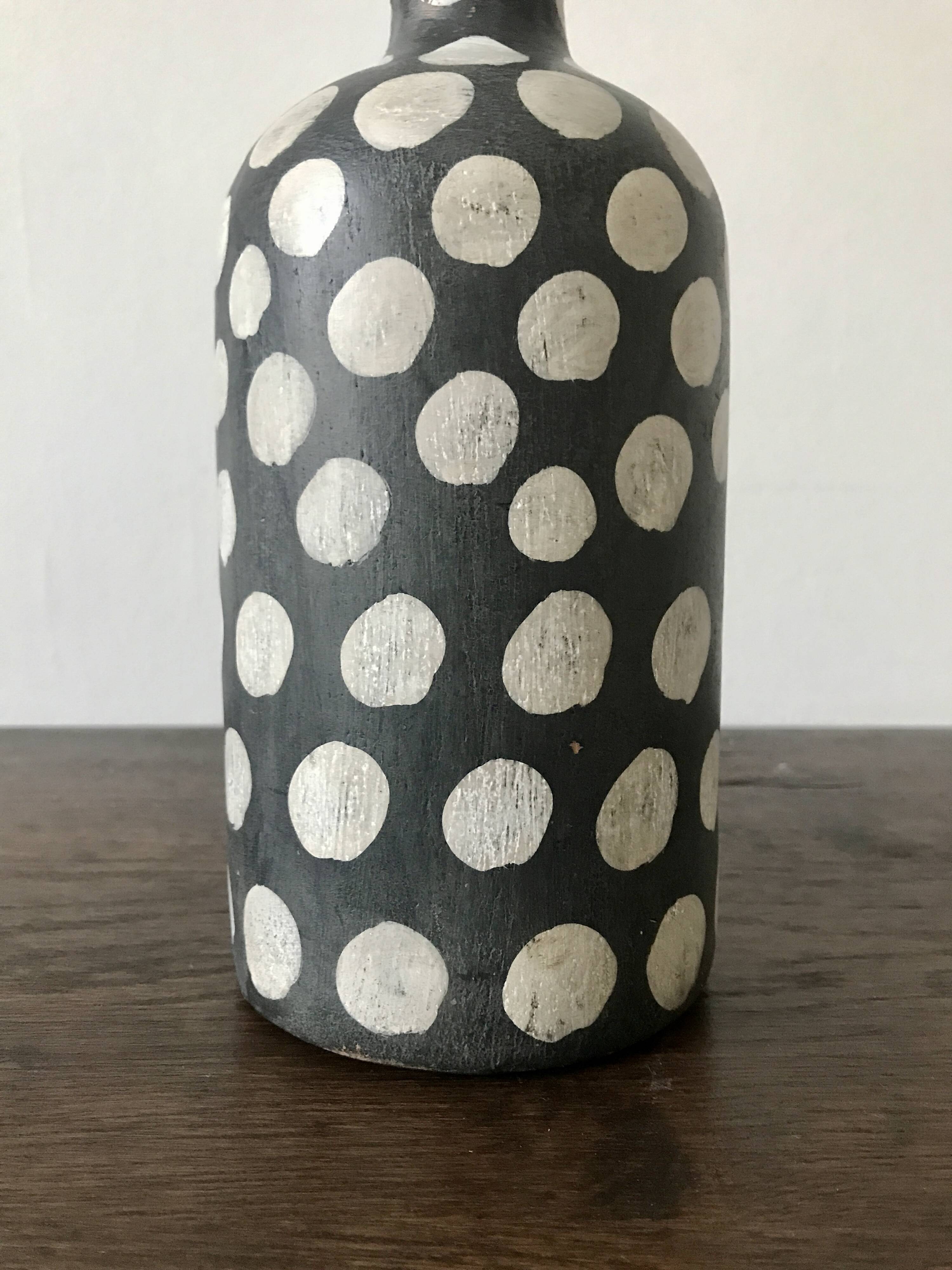 Terracotta vase painted with polka dots