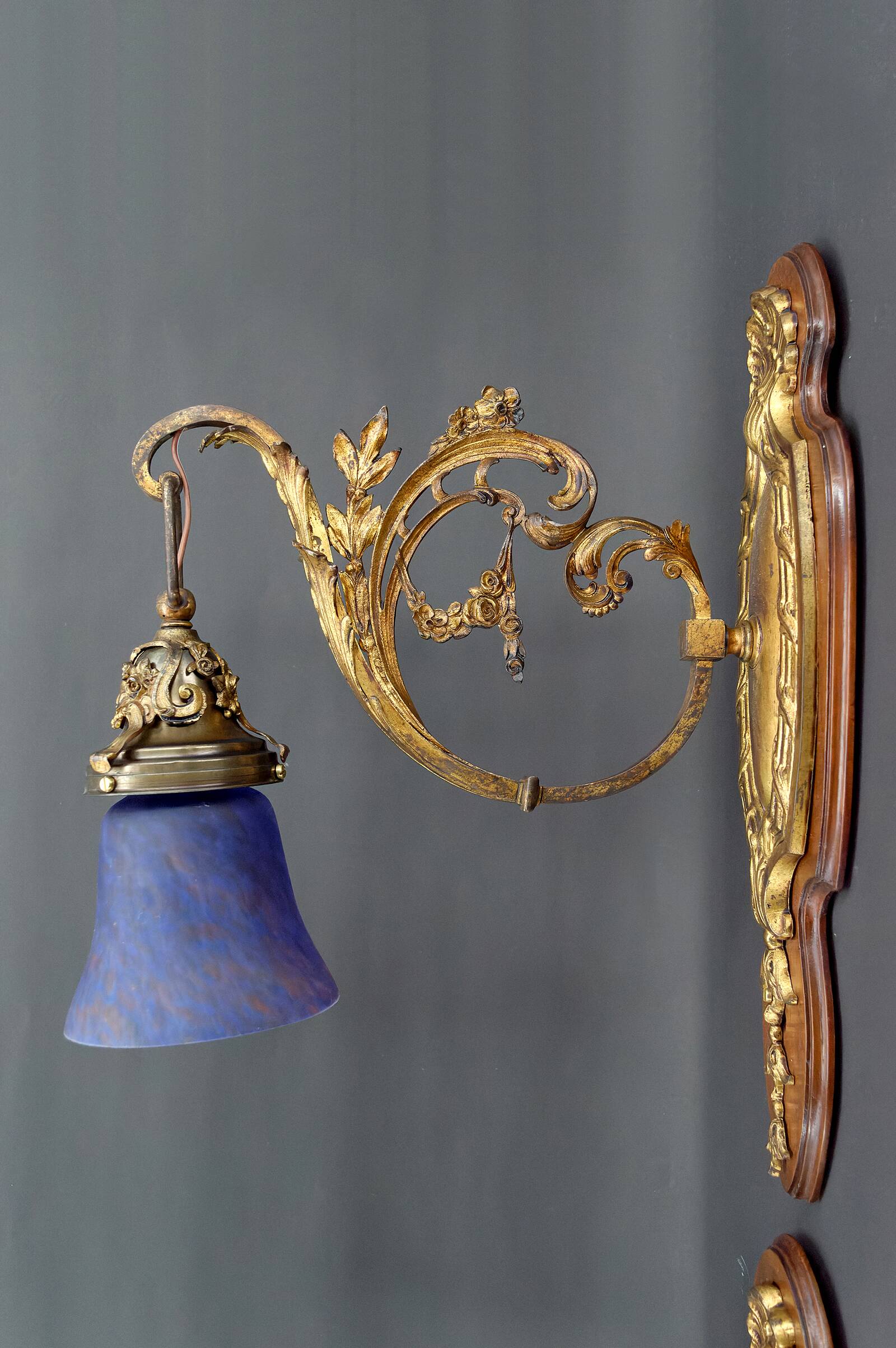 Pair of Rococo / Louis XV wall lights in gilded bronze, walnut bases and glass tulips, France, Circ