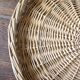 Large round wicker tray with two handles, vintage weaving.
