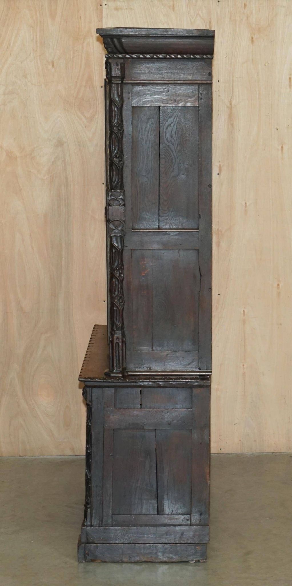 Jacobean hardwood library with carved panels and glass doors.